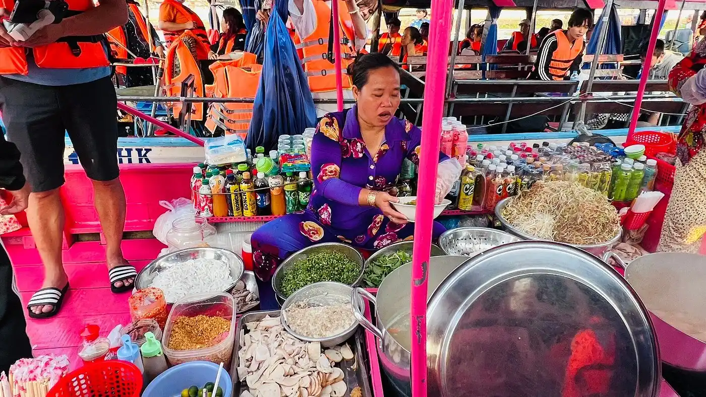 Seller cooking food on the boat