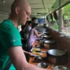 Tourists trying to make a Vietnamese pizza