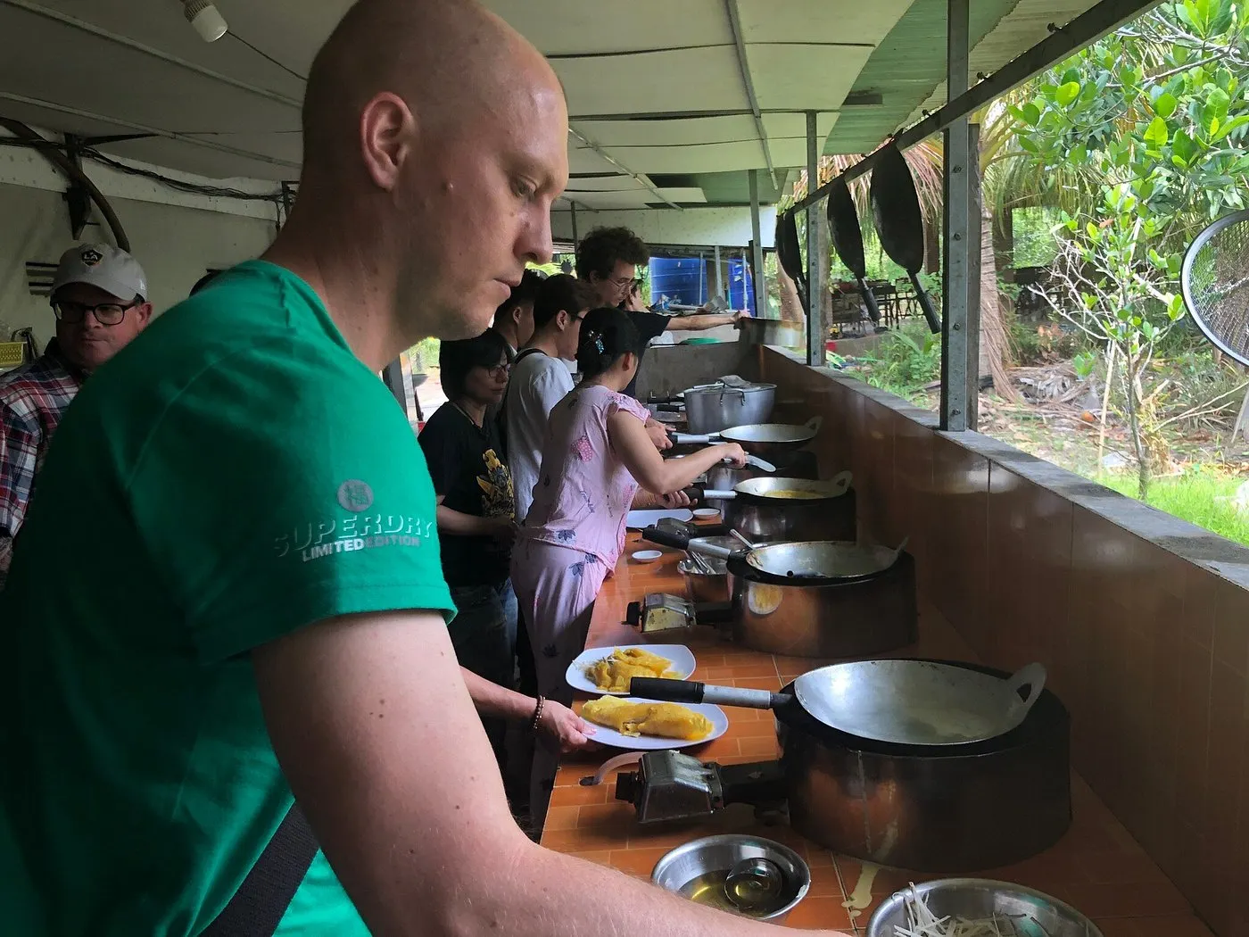 Tourists trying to make a Vietnamese pizza