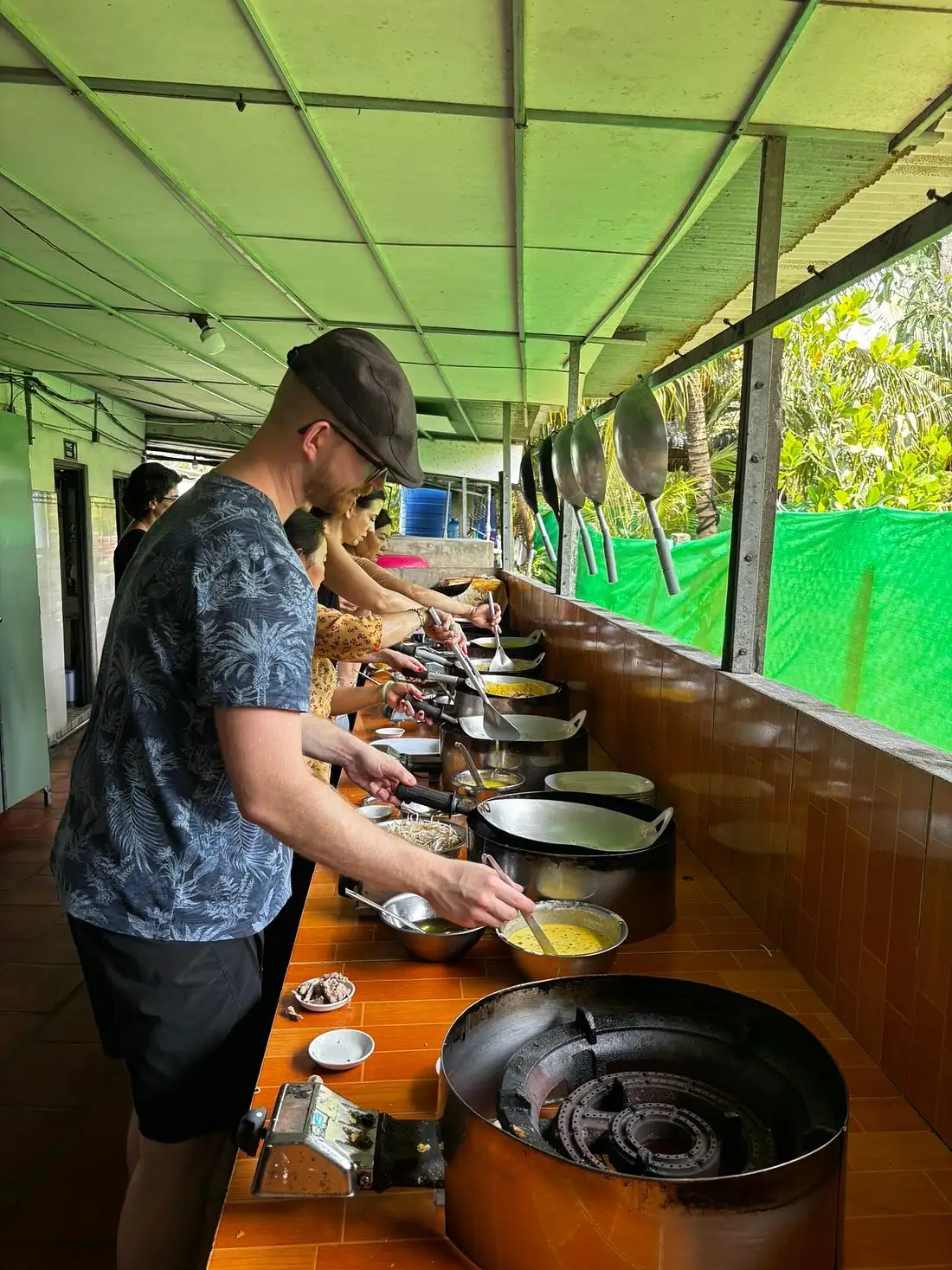 Trying make the rice noodle pizza with local people