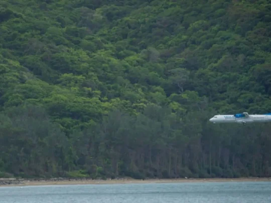 Aircraft landing near Vong Beach surrounded by Con Dao tropical forest