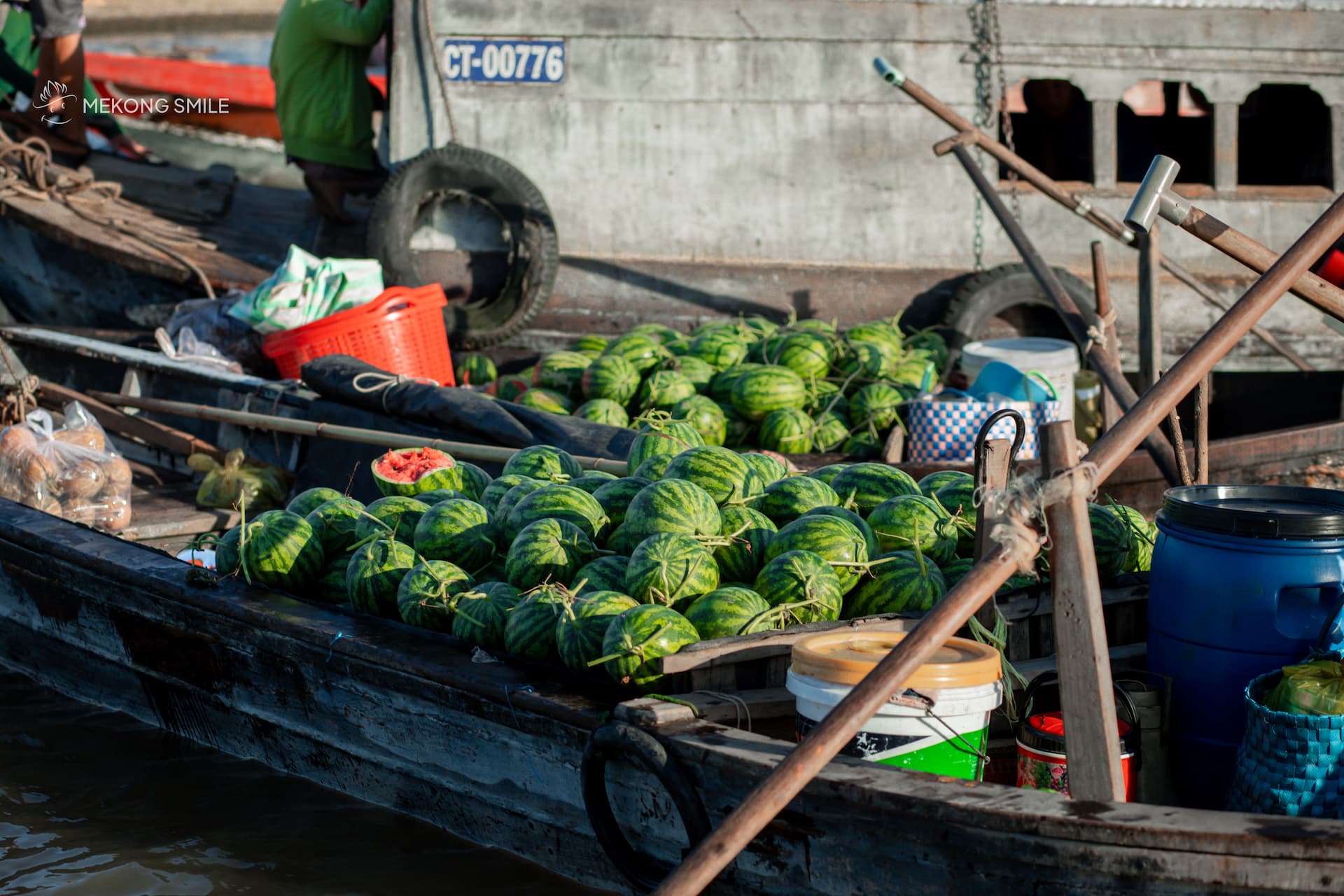 Cai Rang Floating Market: The Rhythmic Soul of the Mekong 283 A vendor's boat filled to the brim with a vibrant display of fresh watermelons at the floating market.