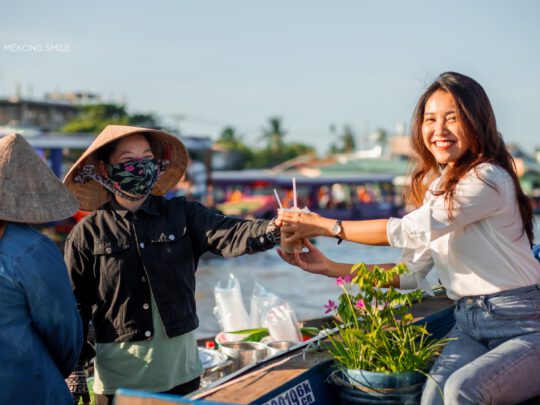 A close-up shot of a friendly local's face, capturing the warmth and hospitality of the people in the Mekong Delta on can tho city tour