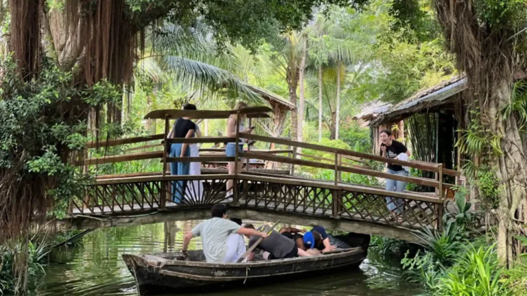 Visitors enjoying a traditional boat ride at Lu Gia Xeo Nhum Ecological Village