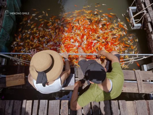 A person reacting to the sensation of a koi fish massage, showcasing a new and interesting experience.