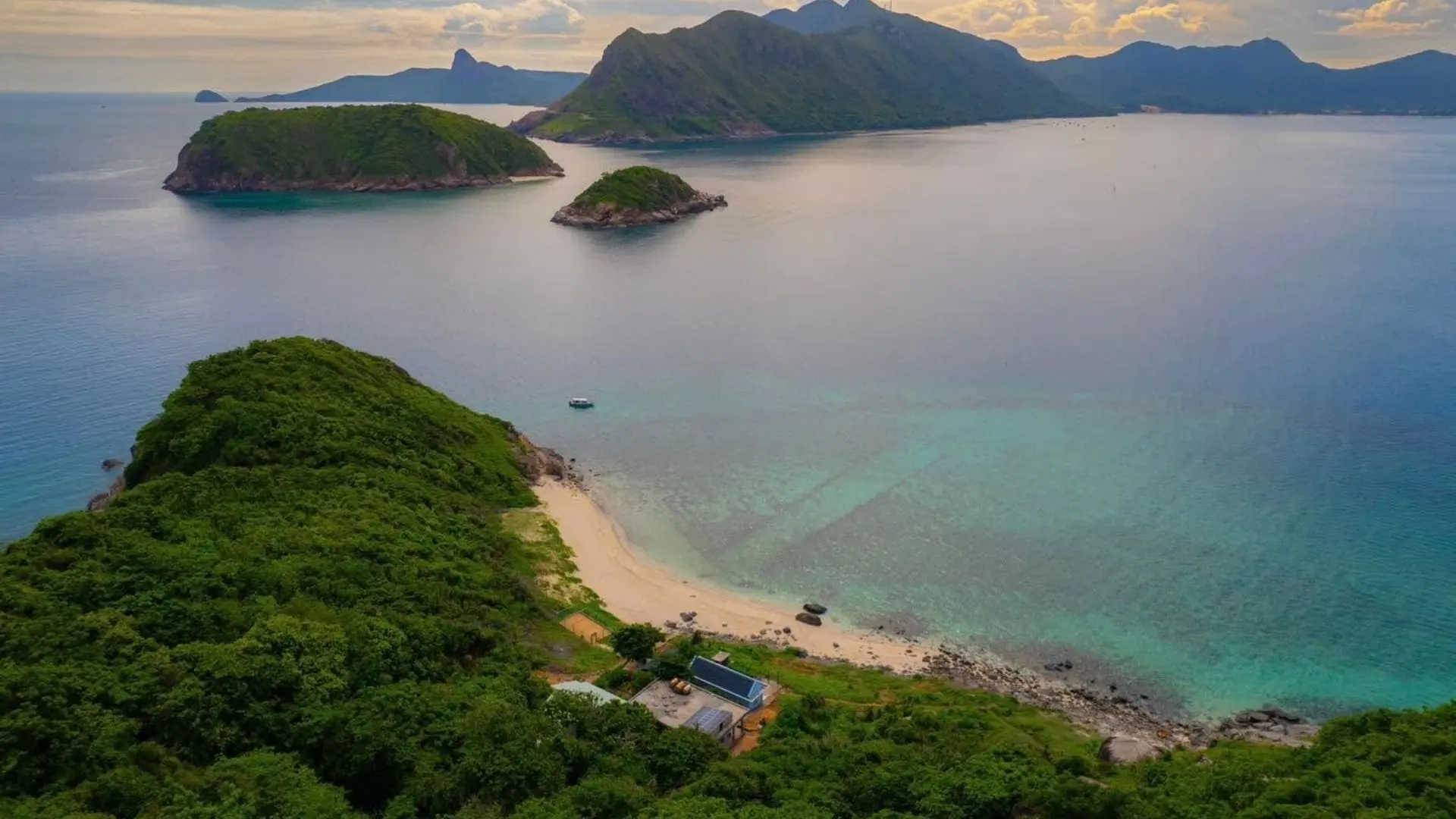 Aerial view of Hon Tai Island with green hills and turquoise sea in Con Dao