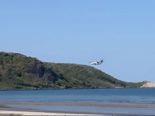 Airplane flying above Vong Beach in Con Dao before the Bamboo Lagoon forest hike