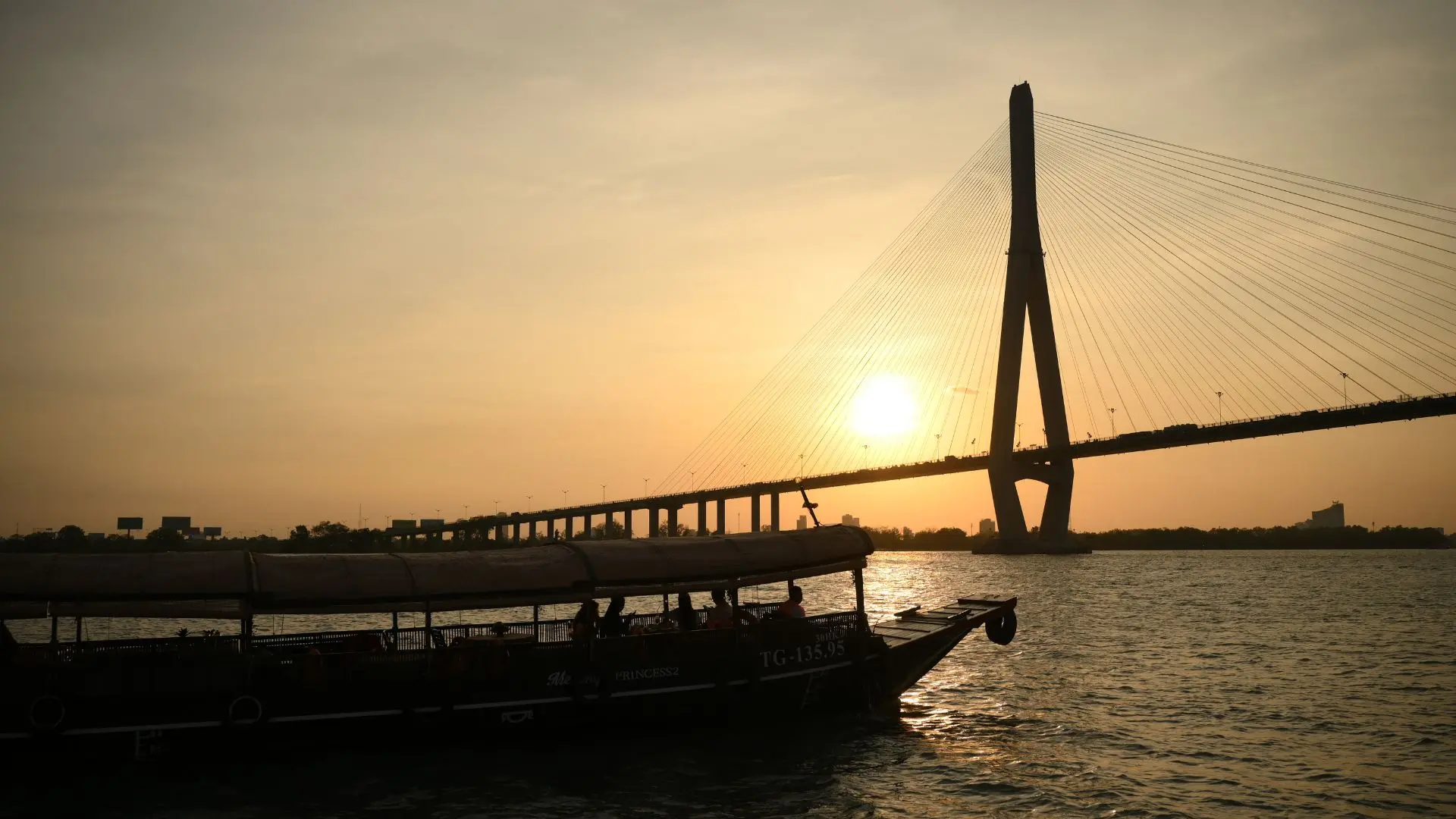 Approaching Can Tho Bridge during a peaceful sunset cruise – Can Tho Sunset Tour by Mekong Smile