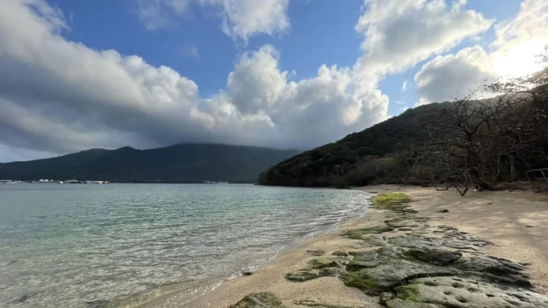 Rocky shoreline and calm coastal water around Ba Island in Con Dao