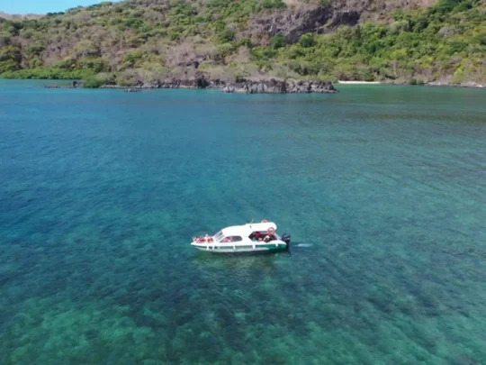 Speedboat traveling across clear water toward Bamboo Lagoon during the Con Dao giant clam snorkeling tour