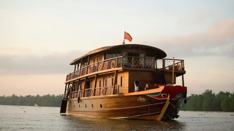 Bassac Cruise Mekong Delta traditional boat sailing on the river