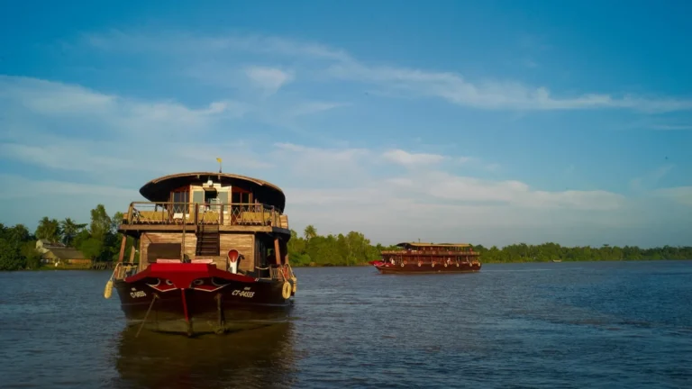 Bassac Cruise Mekong Delta boat sailing along peaceful river landscape