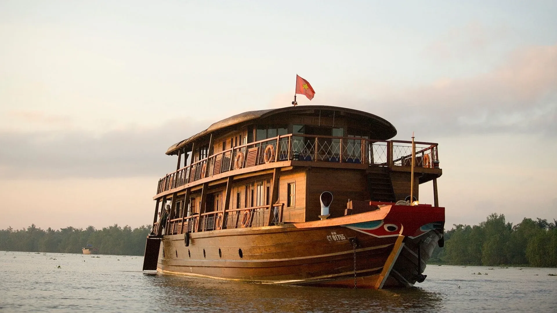 Bassac Cruise Mekong Delta traditional boat sailing on the river
