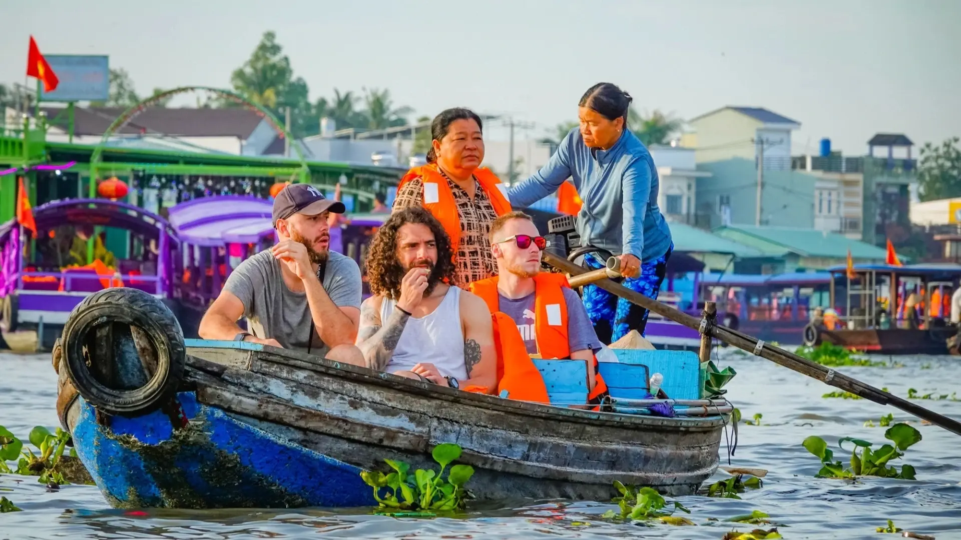 Bassac Cruise Mekong Delta guests touring Cai Rang Floating Market by boat