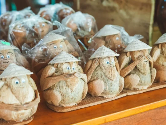 A cute, handcrafted monkey made entirely from coconut shells, a popular souvenir in the Mekong Delta