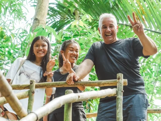 Travelers looking excited and fascinated while exploring a local craft village on their Mekong Smile tour