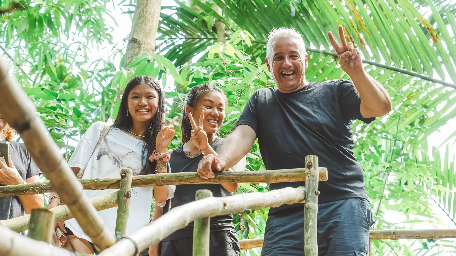 Travelers looking excited and fascinated while exploring a local craft village on their Mekong Smile tour