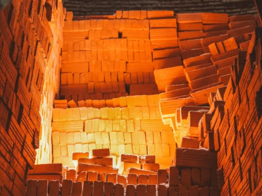 The cavernous interior of an old brick kiln, showing the textured brickwork and scale of the structure