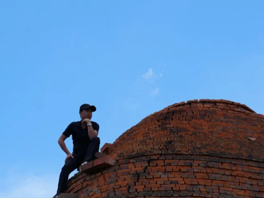 An old, traditional brick kiln standing tall against the sky in a rural area of Ben Tre, Mekong Delta
