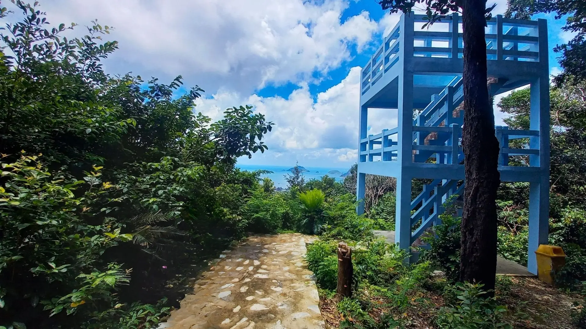 Blue observation tower at So Ray Plantation overlooking forest and ocean in Con Dao.
