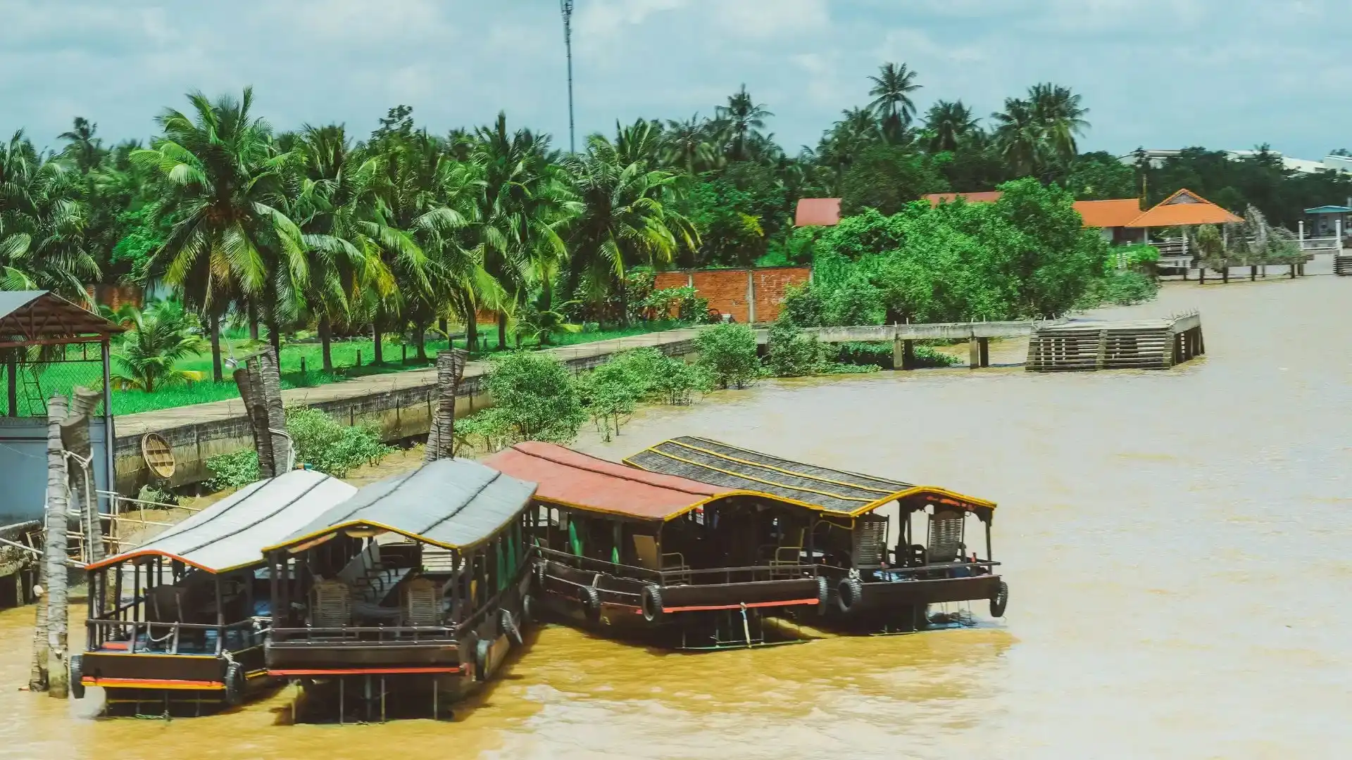 Guests preparing to board a wooden boat during the Ben Tre tour