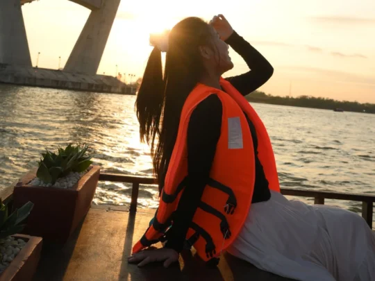 Guest standing on the boat’s bow under sunlight – Mekong Smile Can Tho Sunset Tour