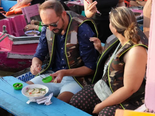 Enjoying breakfast on the boat while cruising through Cai Rang Floating Market
