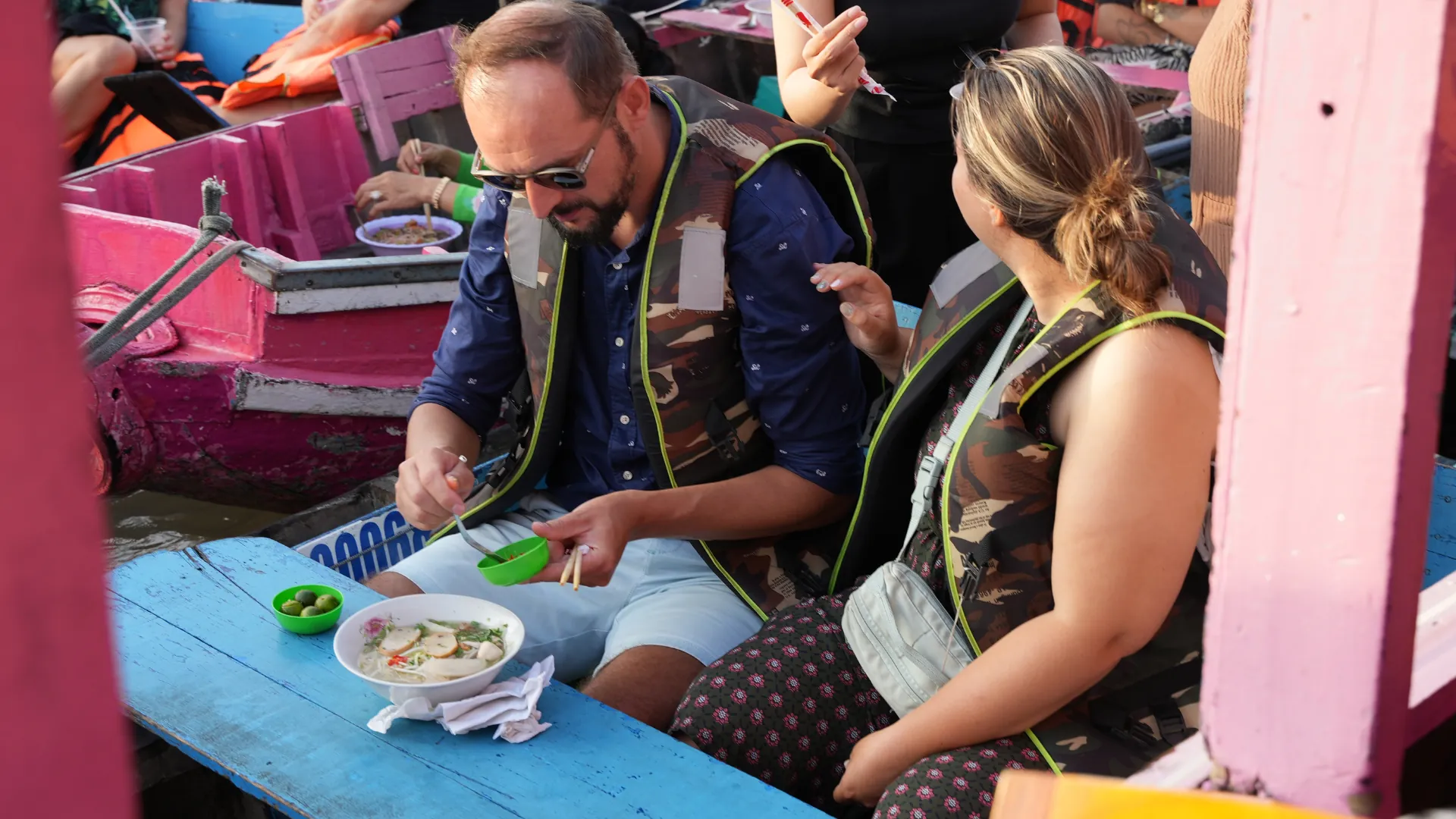 Enjoying breakfast on the boat while cruising through Cai Rang Floating Market