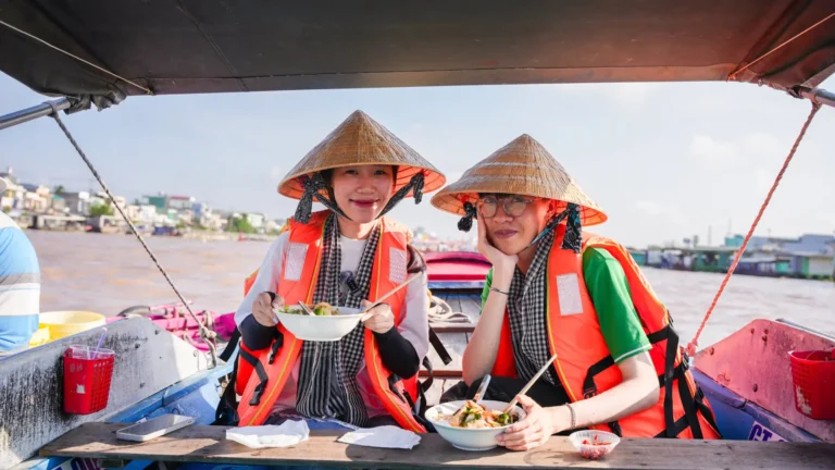 Enjoy breakfast on the water at Cai Rang Floating Market Can Tho with noodle soup, coffee, and local treats