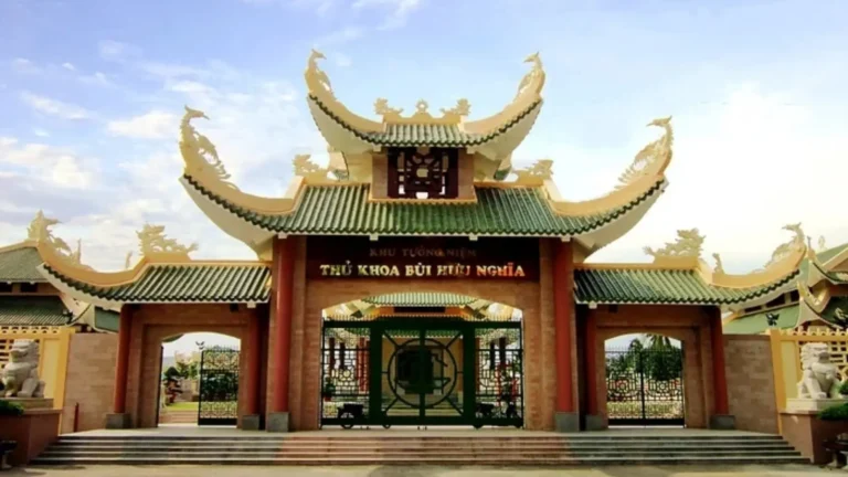 Main entrance gate of Bui Huu Nghia Memorial with green-tiled roofs and decorative roof details