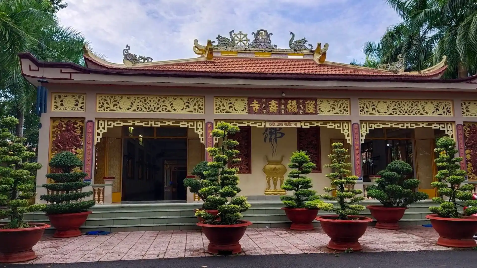 The main sanctuary facade of Buu Lam Pagoda in the sun