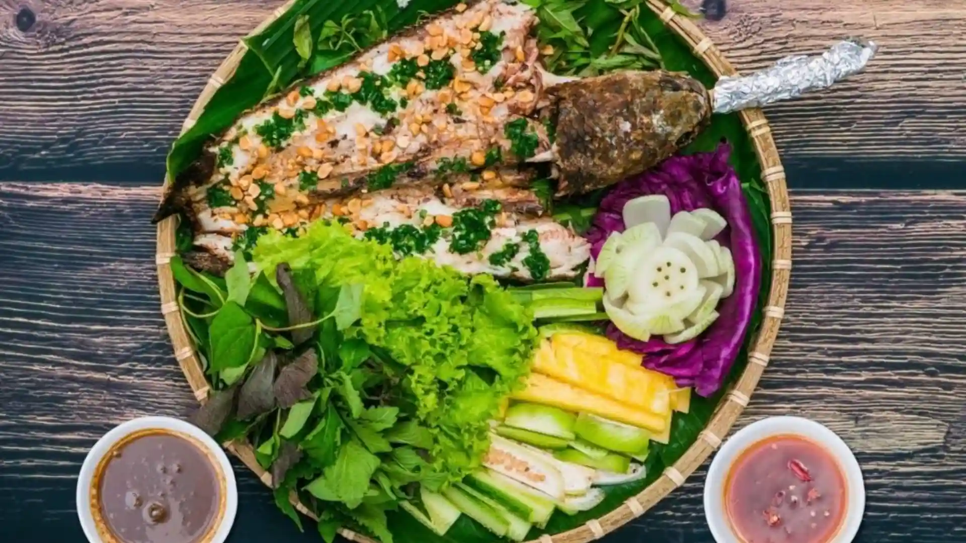 What to Eat in Vietnam: 30 Must-Try Dishes 103 Whole fire-roasted snakehead fish served with fresh vegetables