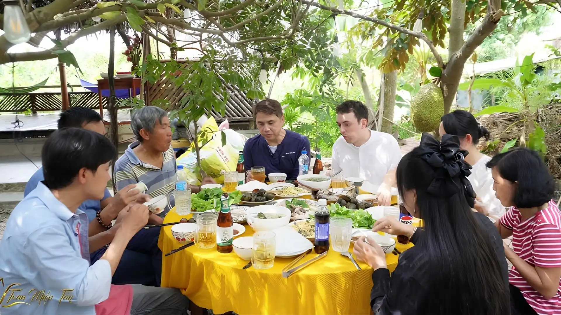 Travelers enjoying a local Vietnamese meal at Cai Mon Orchard Village