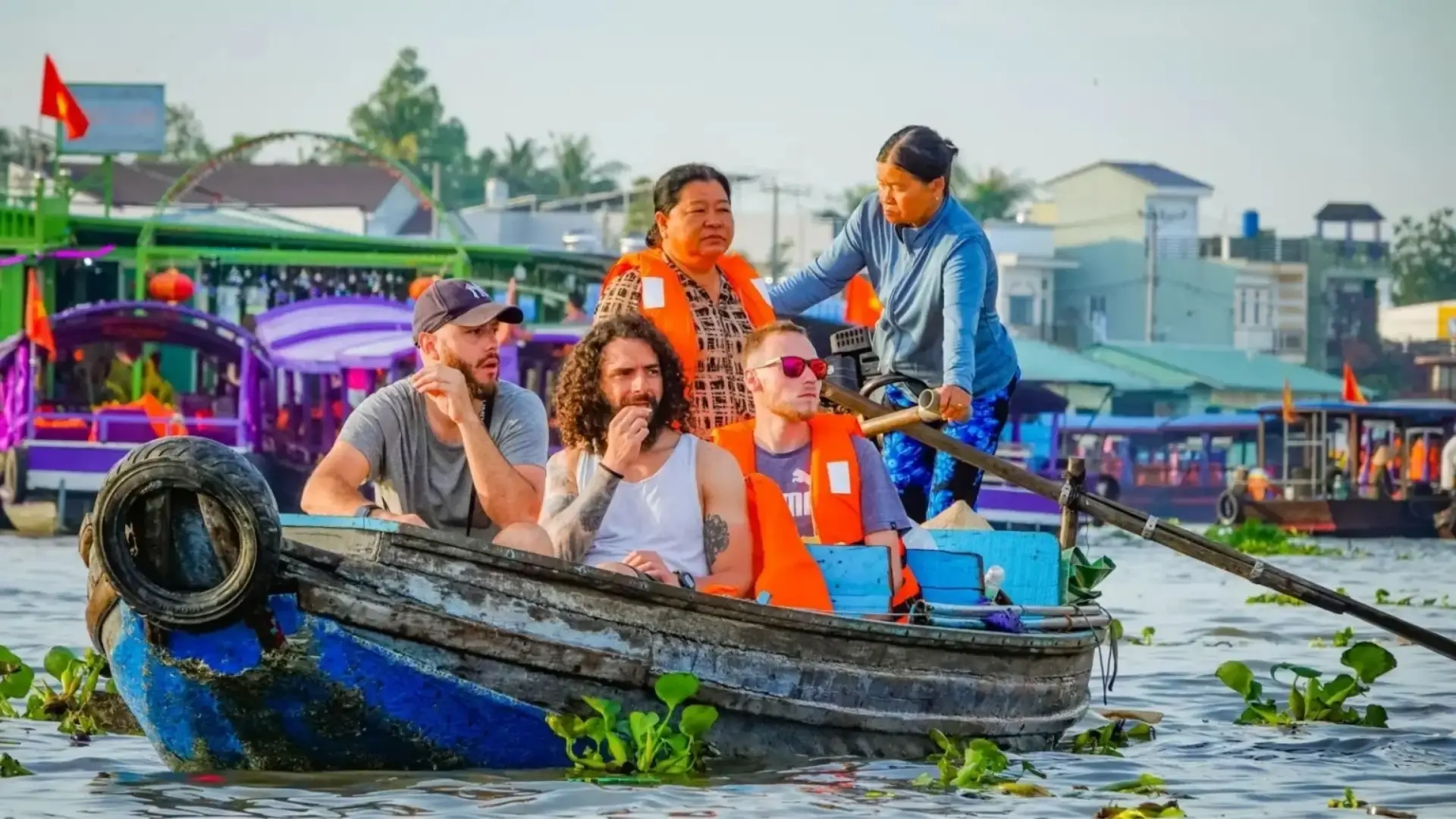 When to Visit the Mekong Delta: Weather, Seasons & What to Expect 7 Travelers on a boat at Cai Rang Floating Market in Can Tho