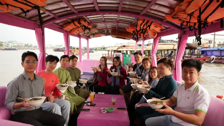 Tourists enjoy breakfast and local culture at Cai Rang Floating Market