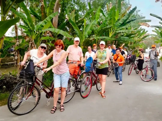 A group of travelers gathering to pick up their bicycles at the start of the Can Tho bike tour.