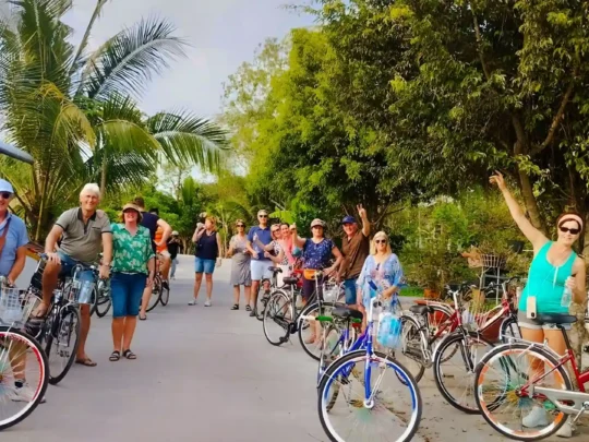 The excited atmosphere of a tour group at the beginning of their cycling journey through the Mekong Delta.