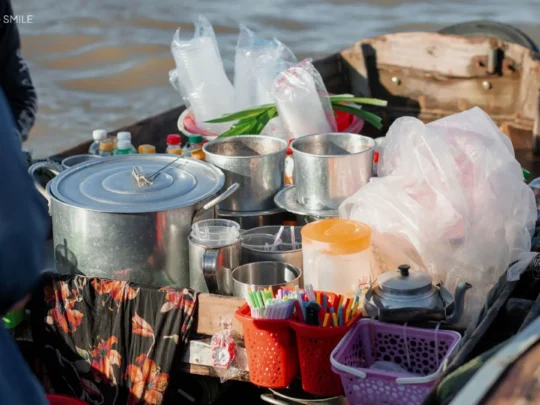A small, functional kitchen on a boat, demonstrating how vendors cook and serve food directly on the water at Cai Rang floating market tour