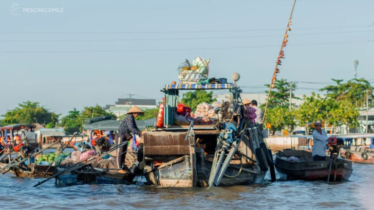 A bustling scene of boats and vendors trading goods at the Cai Rang Floating Market, showcasing the unique river life of the Mekong Delta.
