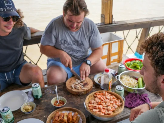 Various traditional dishes, like spring rolls and soups, beginning to take their final form on a cooking station.