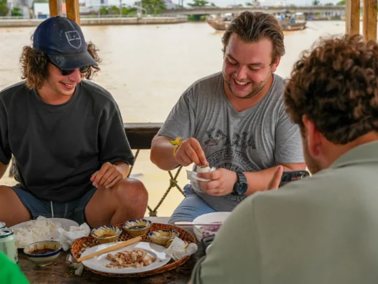 A group of travelers enjoying their meal, tasting the signature dishes they prepared in the cooking class.