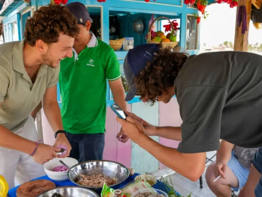 A group preparing ingredients, such as chopping vegetables, at the beginning of a hands-on cooking class.