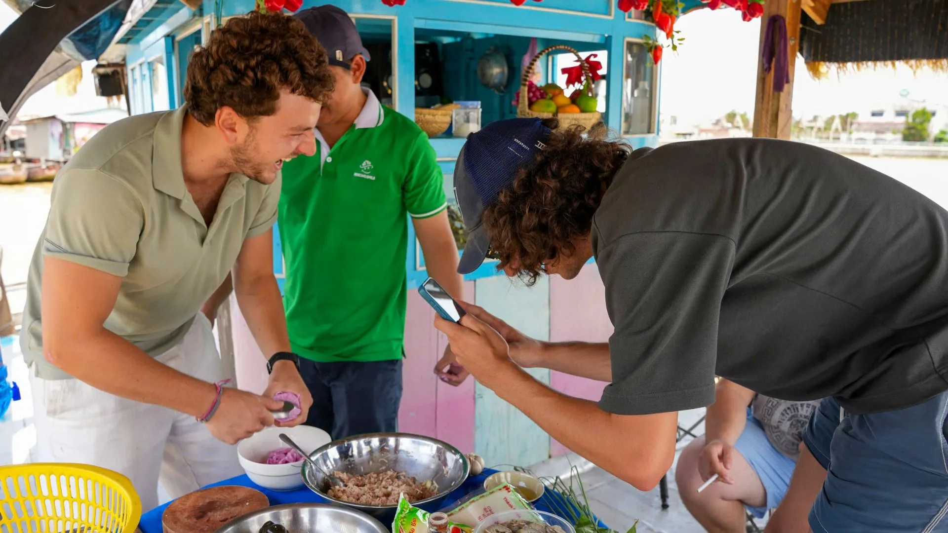 A group preparing ingredients, such as chopping vegetables, at the beginning of a hands-on cooking class.