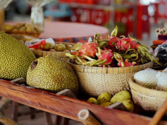 A vibrant display of various seasonal fruits like durian, mangosteen, and rambutan, a highlight of a Cai Rang floating market tour
