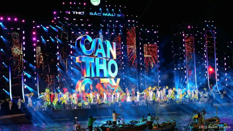 Performers on a colorful outdoor stage with boats in the foreground in Can Tho