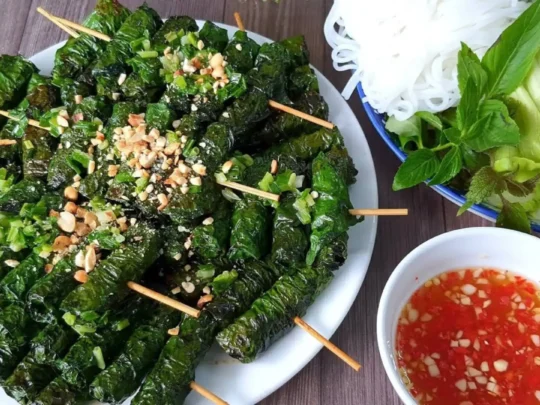 A variety of delicious wrapped dishes ready to be dipped into a savory dipping sauce, a classic Vietnamese eating style.