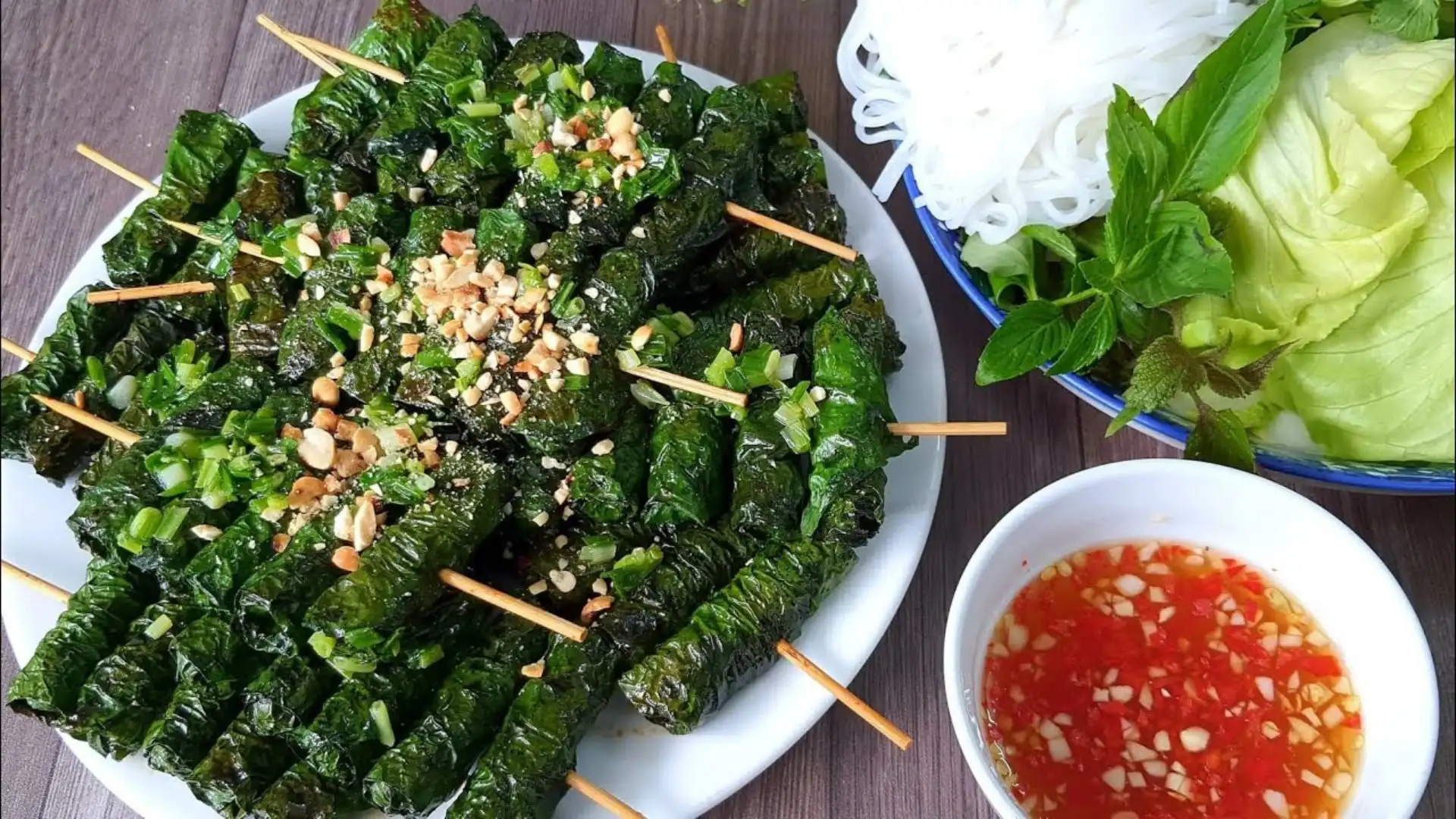 A variety of delicious wrapped dishes ready to be dipped into a savory dipping sauce, a classic Vietnamese eating style.