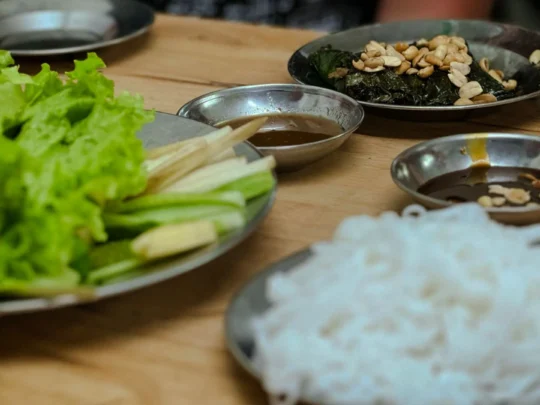 A platter of Bo La Lot, a traditional Vietnamese dish of seasoned beef wrapped in fragrant wild betel leaves.