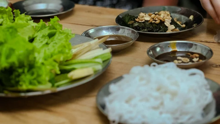 A platter of Bo La Lot, a traditional Vietnamese dish of seasoned beef wrapped in fragrant wild betel leaves.