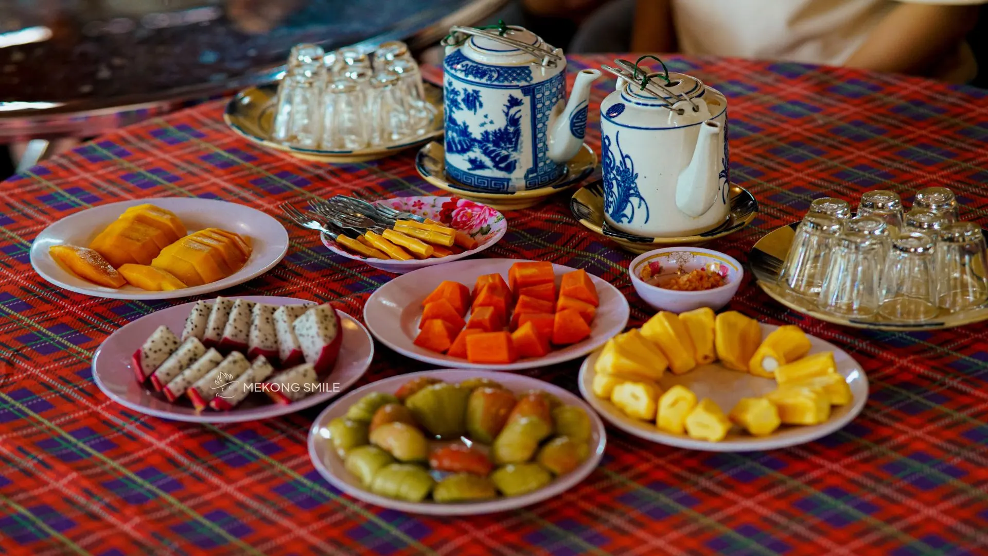 A plate of colorful, pre-cut tropical fruits, ready to be enjoyed by tourists after a long day of exploring.